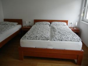 a bed room with two beds and two lamps at Rooms & Apartment Mira G. in Postojna