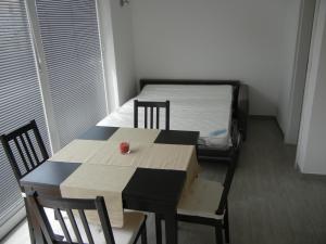 a table and chairs in a room at Rooms & Apartment Mira G. in Postojna
