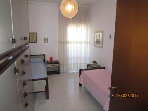 a small bedroom with two beds and a window at Casa Mare di Ponente in Erice