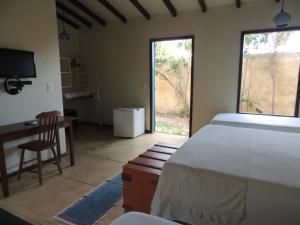 A bed or beds in a room at Pousada Chica Pitanga