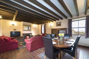 a living room with a table and chairs and a couch at Conwy Valley Cottages in Conwy