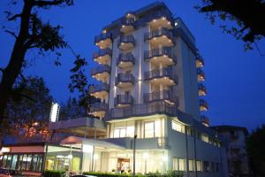 a building with balconies on the side of it at Hotel Grifone in Rimini