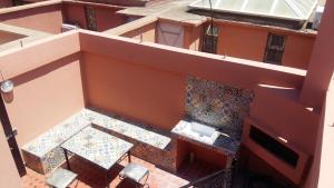 an overhead view of a balcony with a table and chairs at Riad Lalla Zahra in Marrakech
