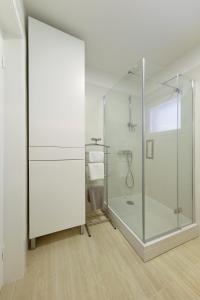 a bathroom with a glass shower with a toilet at Valadar Apartments in Privlaka +39 photos