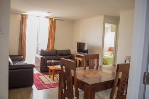 sala de estar con mesa y sofá en Condominio Mistral V, en La Serena