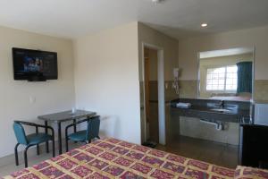 a hotel room with a bed and a sink at Florentina Motel - Los Angeles in Los Angeles