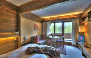 a bedroom with a bed and a living room at Alt Mösern in Seefeld in Tirol
