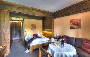 a hotel room with a bed and a couch at Alt Mösern in Seefeld in Tirol