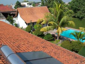 an overhead view of a roof of a house with a swimming pool at Hotel Tulips in Yogyakarta