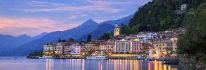a town on the water in front of a mountain at Appartamenti Volta in Como