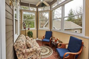 a screened in porch with a couch and two chairs at Andon-Reid Inn Bed & Breakfast in Waynesville