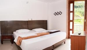 A bed or beds in a room at Rincon Oibano