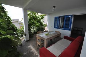 a living room with a red couch and a table at Holidayhome Florecka in Utjeha +15 photos