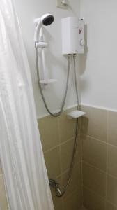 a shower in a bathroom with a shower curtain at Trees Residences SMDC by Jhoms in Manila