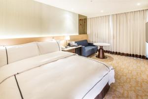 Postel nebo postele na pokoji v ubytování K Hotel Tianjin
