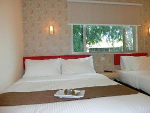 Postel nebo postele na pokoji v ubytování Carlsun Hotel