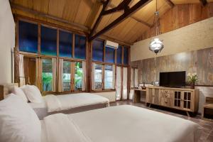 Tempat tidur dalam kamar di Desa Alamanis Resort Vila