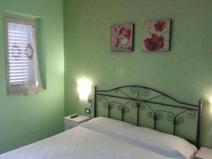 a bedroom with a bed and two pictures on the wall at B&B Villa Makkalè in Vieste