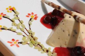 a plate of food with a piece of cheese and cherries at Hotel-Restaurant Früchtl in Zandt