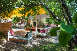 a group of tables and chairs under a tent at Sakura Guesthouse in Bishkek