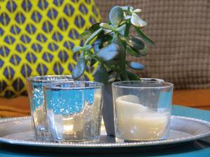 a plate with two glasses and a candle on a table at Pensión Don Claudio in Bilbao