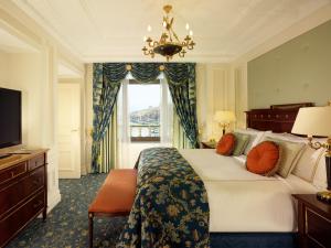 a bedroom with a large bed and a window at Fairmont Grand Hotel Kyiv in Kyiv