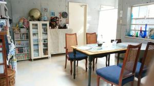 a dining room with a table and chairs at Guesthouse Seaglass in Itoman