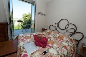 a bed with a laptop and a bag on it at Bella Vista Barbaresco in Barbaresco +16 photos