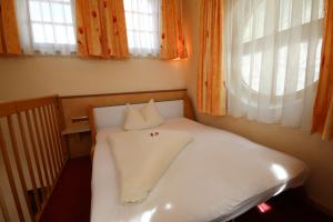Ένα ή περισσότερα κρεβάτια σε δωμάτιο στο Hotel Gasthof Neuner