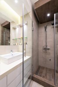 a bathroom with a sink and a shower at Vivio Luxury Apartment in Belgrade