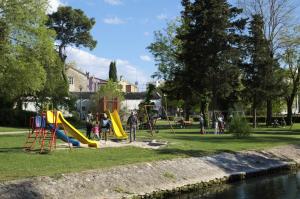 a park with a playground next to a river at Apartment Cvita in Zadar