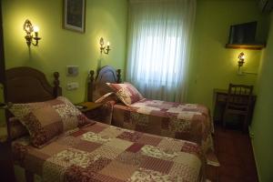 Postel nebo postele na pokoji v ubytování Hostal Mizmaya