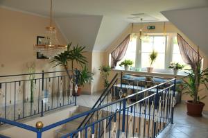 a staircase in a house with potted plants at Pension Thermensonne in Jennersdorf