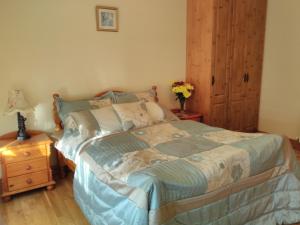 a bedroom with a bed and a table with a night stand at Causeway Country Lodge in Causeway