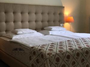 a bedroom with a large bed with a large headboard at Hotel Hvala Superior - Topli Val in Kobarid