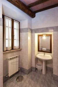 a bathroom with a sink and a toilet at Residenza Palazzo Saloni in Montalcino