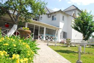 a white house with a walkway in front of it at Maison Blanche Ecohousе in Mytnitsa