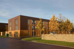 a large brick building with a fence in front of it at UHI Inverness - Campus Accommodation in Inverness