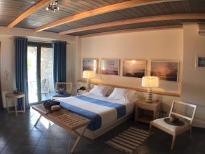 um quarto com uma cama, uma mesa e cadeiras em Melitsina Village Hotel em Kardamili