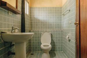 a bathroom with a toilet and a sink at Playa Encantada Beach Resort in El Nido