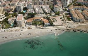 an aerial view of a beach with hotels and buildings at Apartamentos Playa Torrecilla in Nerja