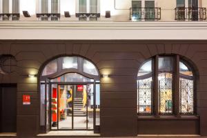 an entrance to a store with two arched windows at ibis Paris Gare De L Est 10ème in Paris