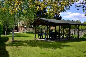 a gazebo with tables and chairs in a park at Hotel Drnholec in Drnholec