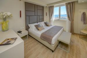 Posteľ alebo postele v izbe v ubytovaní Hotel Villa Garuti