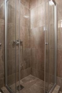 a shower with a glass door in a bathroom at B&T Apartments in Budva