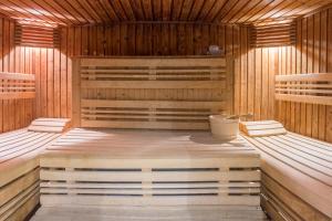 a sauna with wooden walls and wooden floors at La Closerie SPA & Résidence Hôtel in Deauville