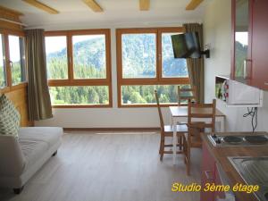 a living room with a couch and a table at Les Terrasses du Lac Blanc - Studios & Appartements in Orbey