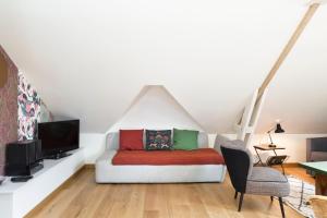 a living room with a couch and a tv at Odorico by Cocoonr in Rennes