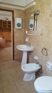 a bathroom with a sink and a toilet at Agriturismo Rebua in Porto Azzurro