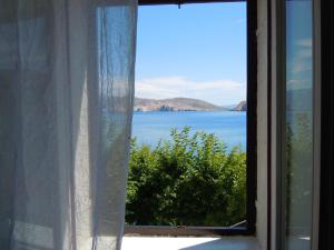 an open window with a view of the ocean at Apartments Luna in Baška